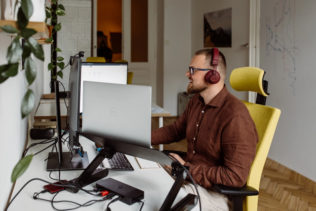 A man sitting in an office working on computers